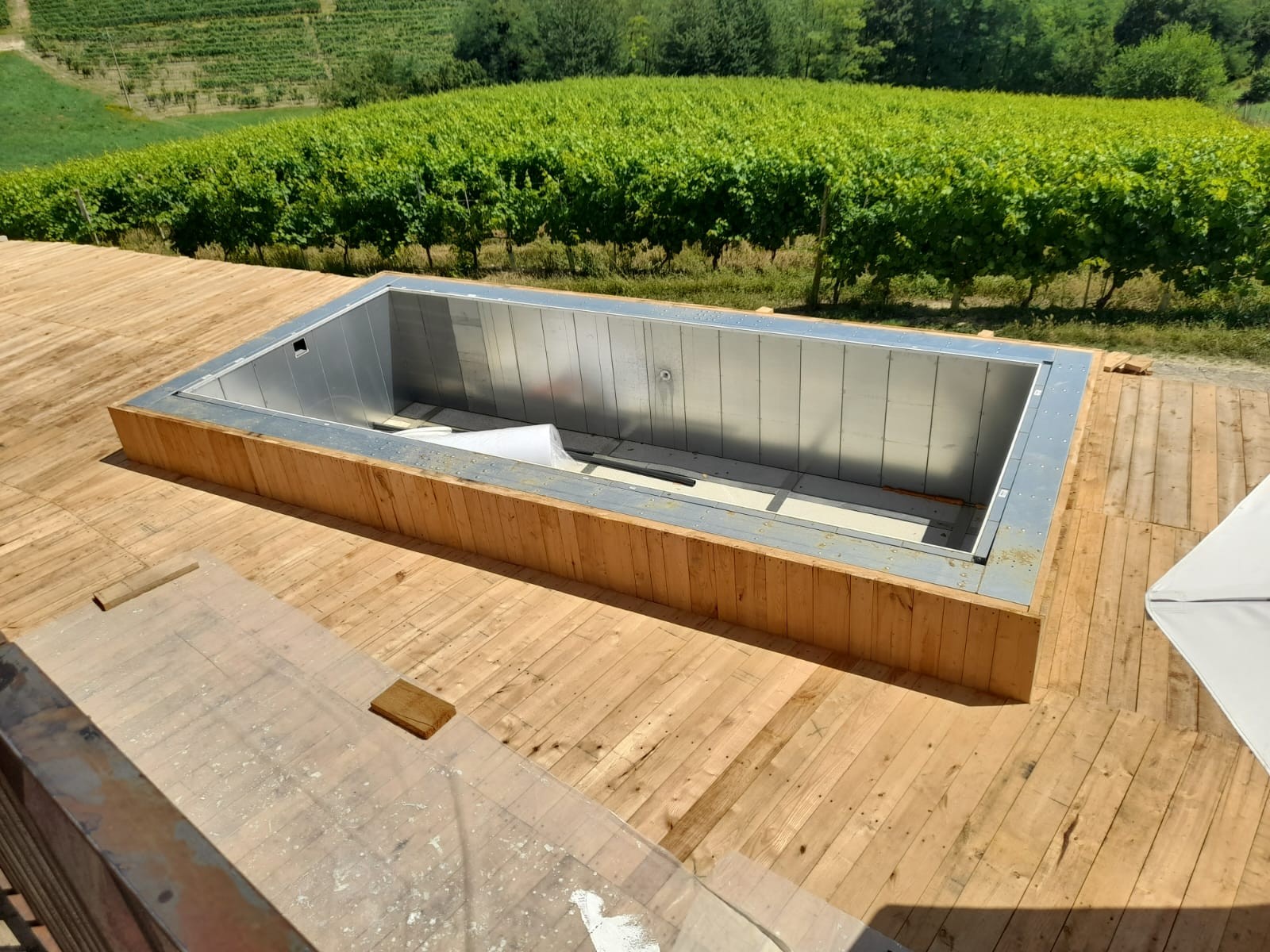 Piscina fuori terra ASTREA 7,8x3 m con bordo in legno immersa nel verde, ideale per giardini e agriturismi
